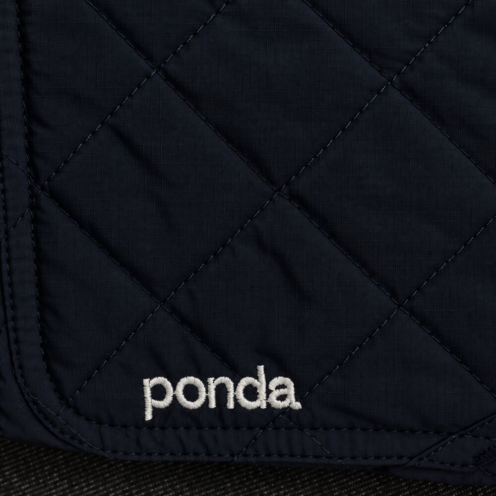 Close-up of diamond quilting with an embroidered ponda wordmark